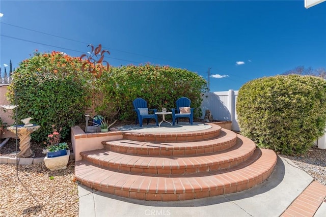 view of patio / terrace featuring fence