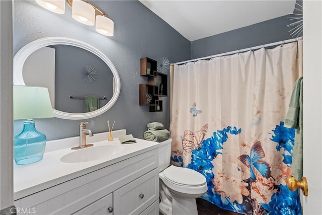 full bathroom with toilet, a textured wall, a shower with curtain, and vanity