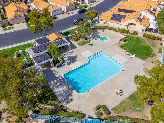 view of swimming pool with a residential view and fence