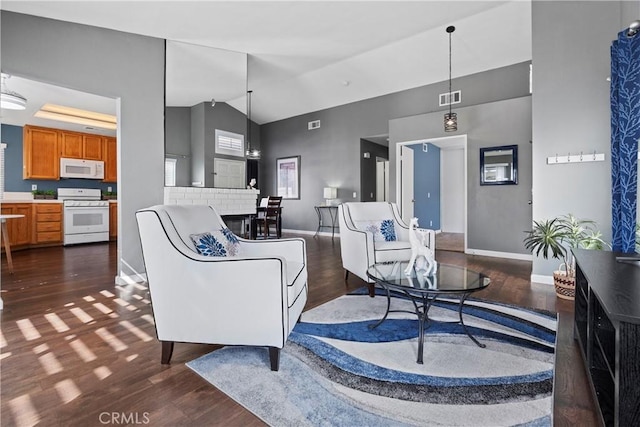 living area featuring high vaulted ceiling, baseboards, visible vents, and dark wood-type flooring