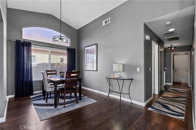 dining space with lofted ceiling, baseboards, visible vents, and wood finished floors