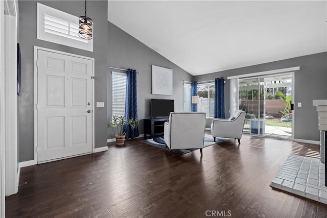 entrance foyer featuring high vaulted ceiling, baseboards, and wood finished floors