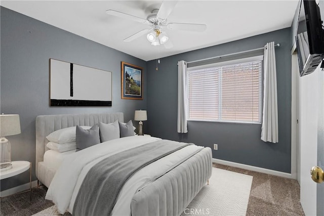 carpeted bedroom with baseboards and a ceiling fan