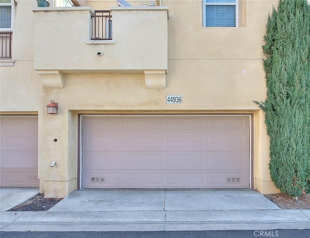 garage with concrete driveway