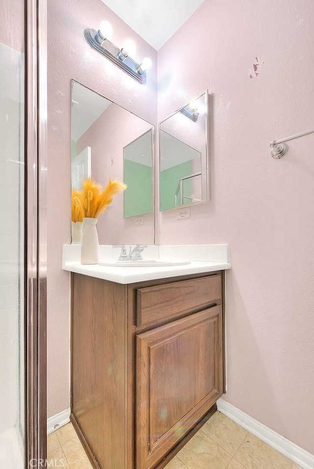 bathroom featuring tile patterned flooring, vanity, and baseboards