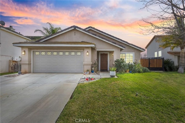 single story home featuring a garage and a yard