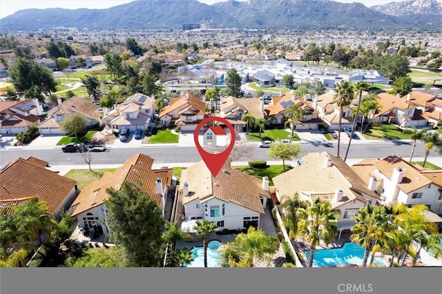 birds eye view of property with a mountain view and a residential view