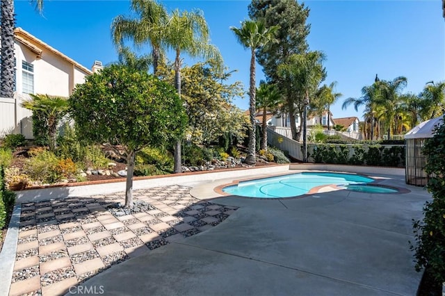 view of pool with a fenced in pool, a patio area, and fence