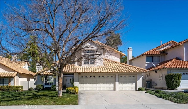 view of front facade featuring a garage, a front yard, driveway, and stucco siding