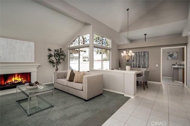 tiled living room featuring a warm lit fireplace, high vaulted ceiling, baseboards, and a notable chandelier