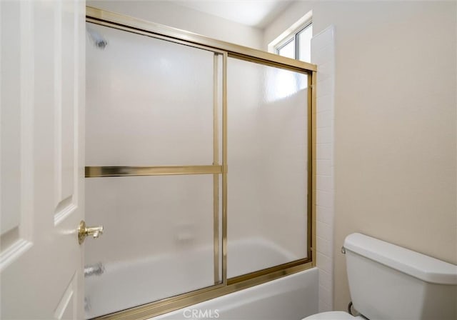 full bathroom featuring bath / shower combo with glass door and toilet