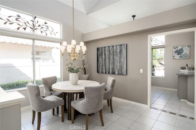 dining area with vaulted ceiling, light tile patterned floors, plenty of natural light, and a chandelier