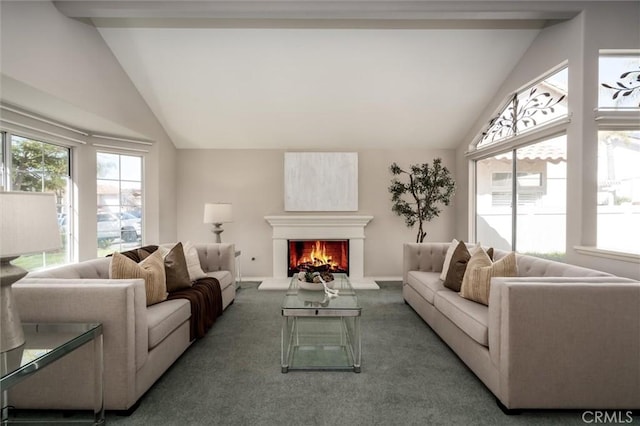 living area featuring a warm lit fireplace, dark carpet, lofted ceiling, and a healthy amount of sunlight