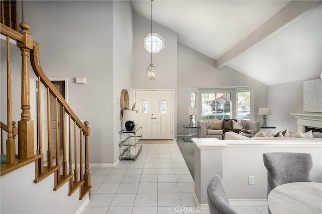 entryway featuring high vaulted ceiling, stairway, baseboards, and light tile patterned floors