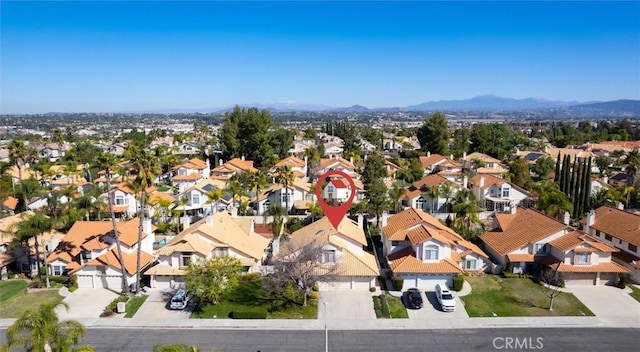 birds eye view of property with a mountain view and a residential view