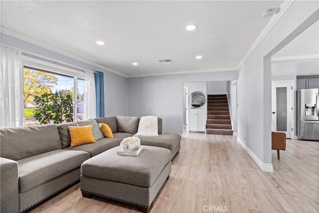 living room featuring ornamental molding and light hardwood / wood-style flooring