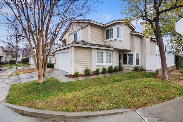 view of property featuring a garage and a front yard