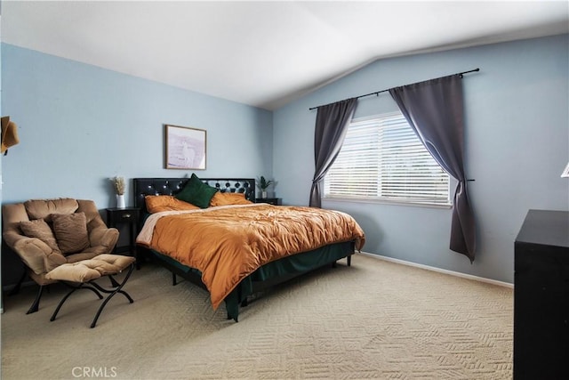 carpeted bedroom with lofted ceiling