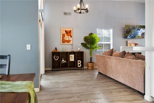 living room featuring wood-type flooring and a chandelier