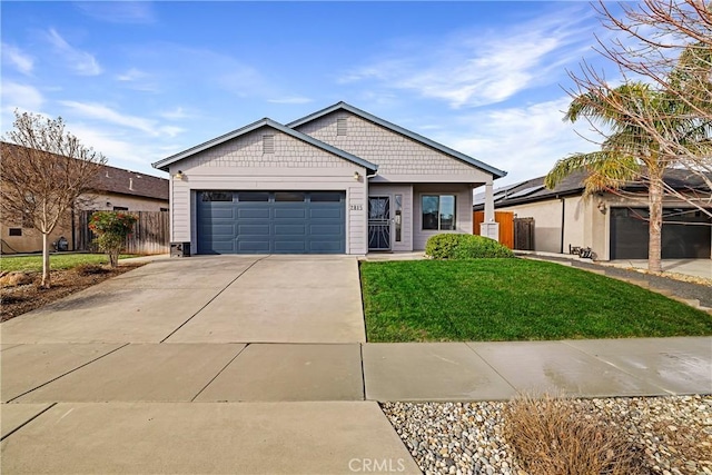 single story home featuring a garage, a front yard, concrete driveway, and fence