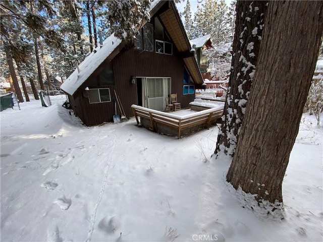 view of snow covered rear of property