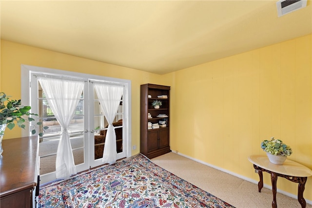 doorway featuring light carpet and visible vents