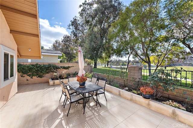 view of patio with a fenced backyard and outdoor dining area