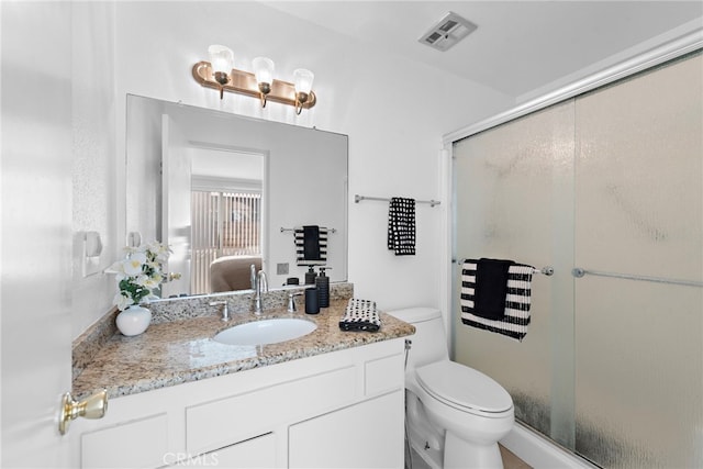 ensuite bathroom featuring toilet, vanity, visible vents, a stall shower, and ensuite bath