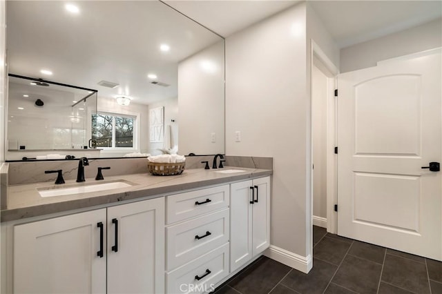 full bathroom with a stall shower, tile patterned flooring, visible vents, and a sink