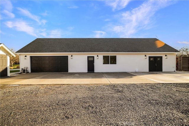 single story home featuring roof with shingles and stucco siding