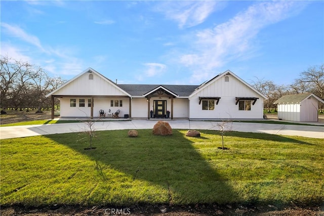 9243 Turner Ln, Durham, CA 95938 - modern inspired farmhouse with board and batten siding, a front lawn, a storage unit, and covered porch
