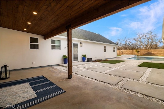 view of patio / terrace with a fenced in pool, central AC, and fence