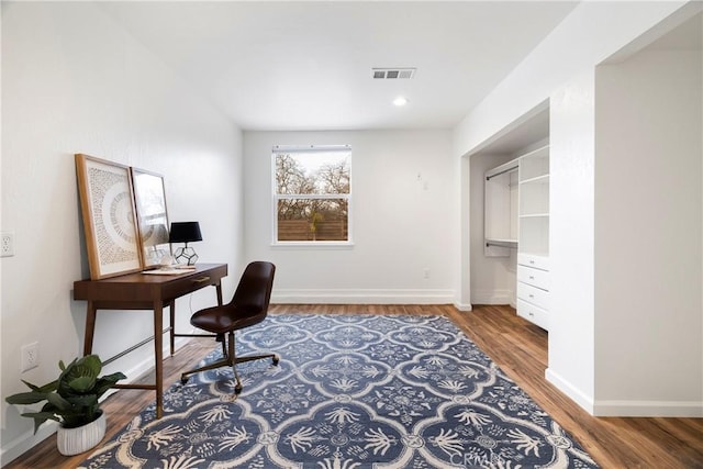 office space featuring visible vents, baseboards, wood finished floors, and recessed lighting