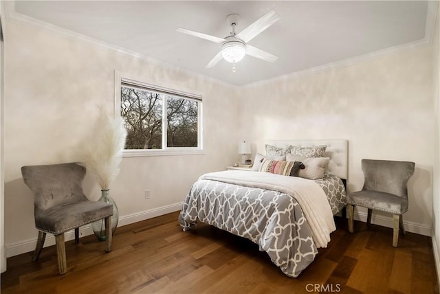 bedroom featuring a ceiling fan, crown molding, baseboards, and wood finished floors