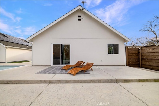 back of property featuring a patio area, fence, and stucco siding