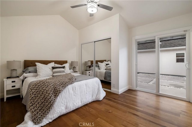 bedroom with baseboards, wood finished floors, access to exterior, vaulted ceiling, and a closet