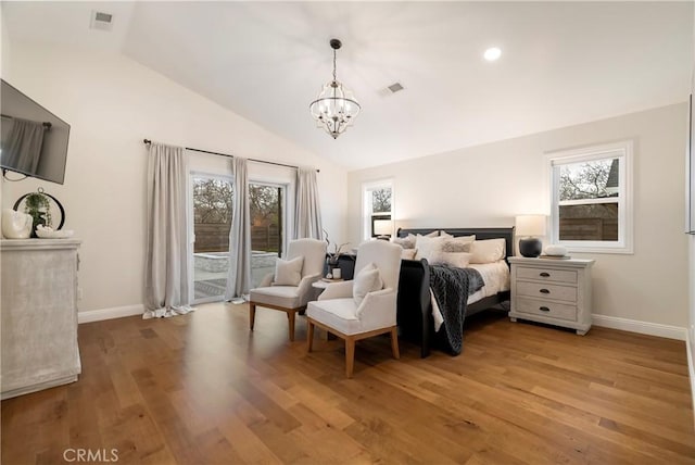 9243 Turner Ln, Durham, CA 95938 - bedroom featuring a chandelier, access to exterior, multiple windows, vaulted ceiling, and light wood-style flooring