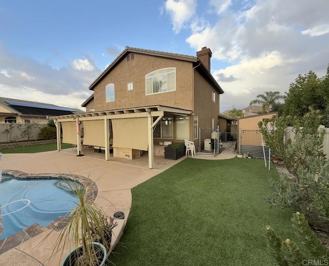 rear view of property with a patio area and a yard