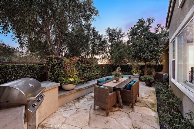 view of patio / terrace with central AC unit, area for grilling, a fenced backyard, outdoor dining space, and grilling area