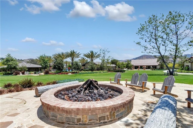 view of patio / terrace with an outdoor fire pit and a mountain view