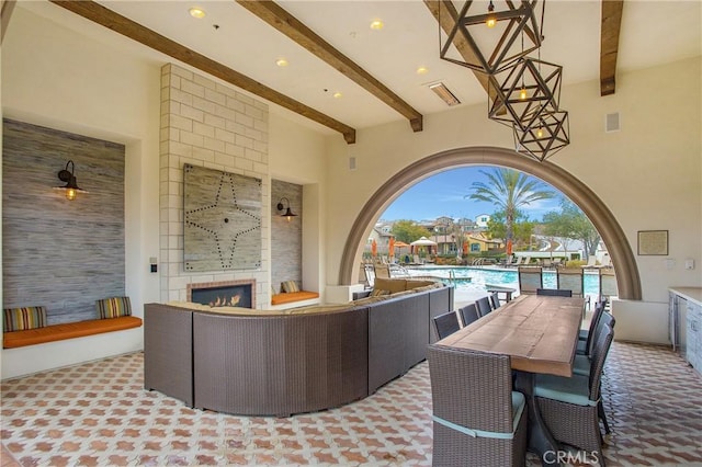 view of patio / terrace featuring a community pool, visible vents, an outdoor living space with a fireplace, and outdoor dining space