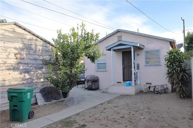 rear view of property featuring a patio