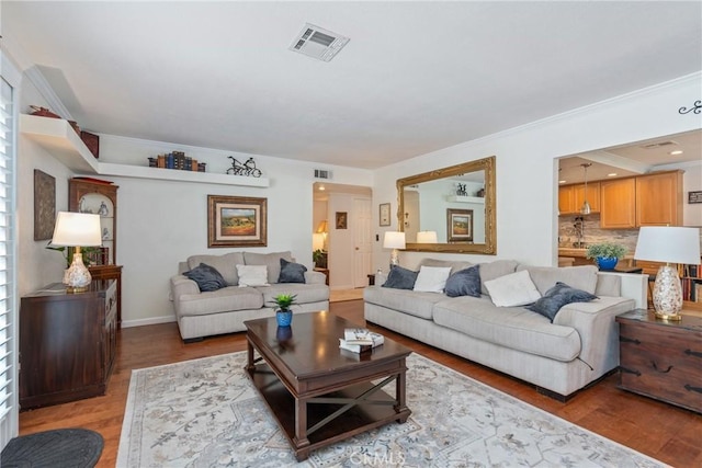 living room with crown molding and light hardwood / wood-style flooring