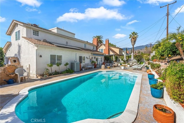 view of pool with central AC and a patio area