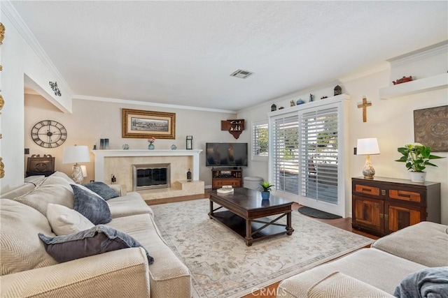 living room with ornamental molding, a premium fireplace, and hardwood / wood-style floors