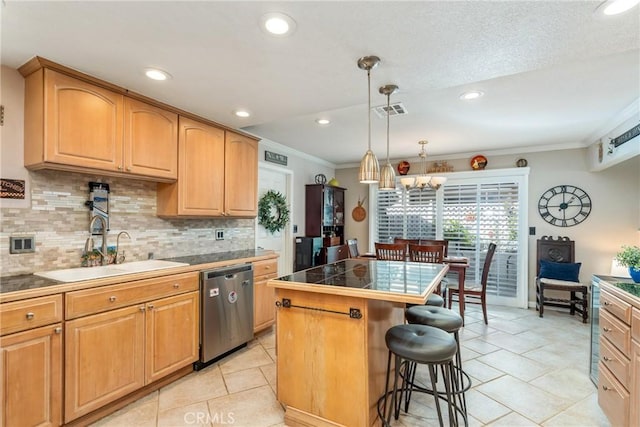 kitchen featuring hanging light fixtures, a center island, sink, stainless steel dishwasher, and tasteful backsplash