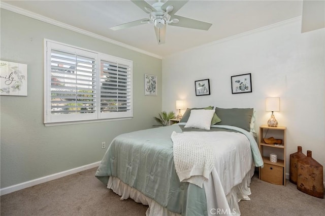 carpeted bedroom featuring ceiling fan and crown molding