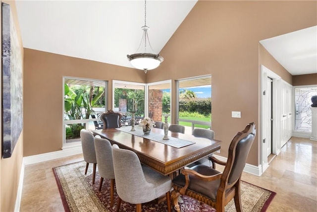 dining area with high vaulted ceiling, a wealth of natural light, and baseboards