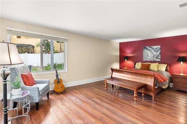 bedroom featuring wood finished floors and baseboards