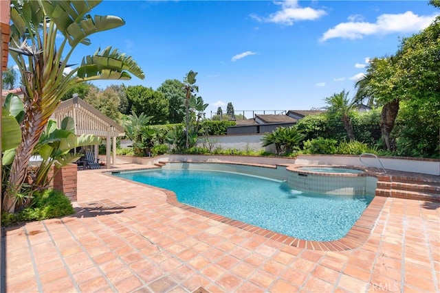 view of pool with a patio and a pool with connected hot tub